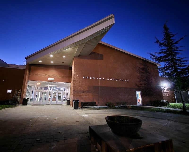 Chemawa Indian School's school dormitory building illuminated at night.