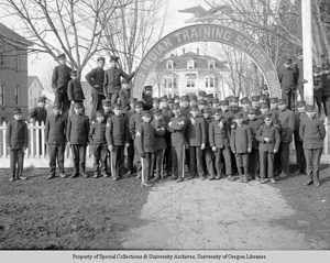 large group of male students in uniform standing outside school